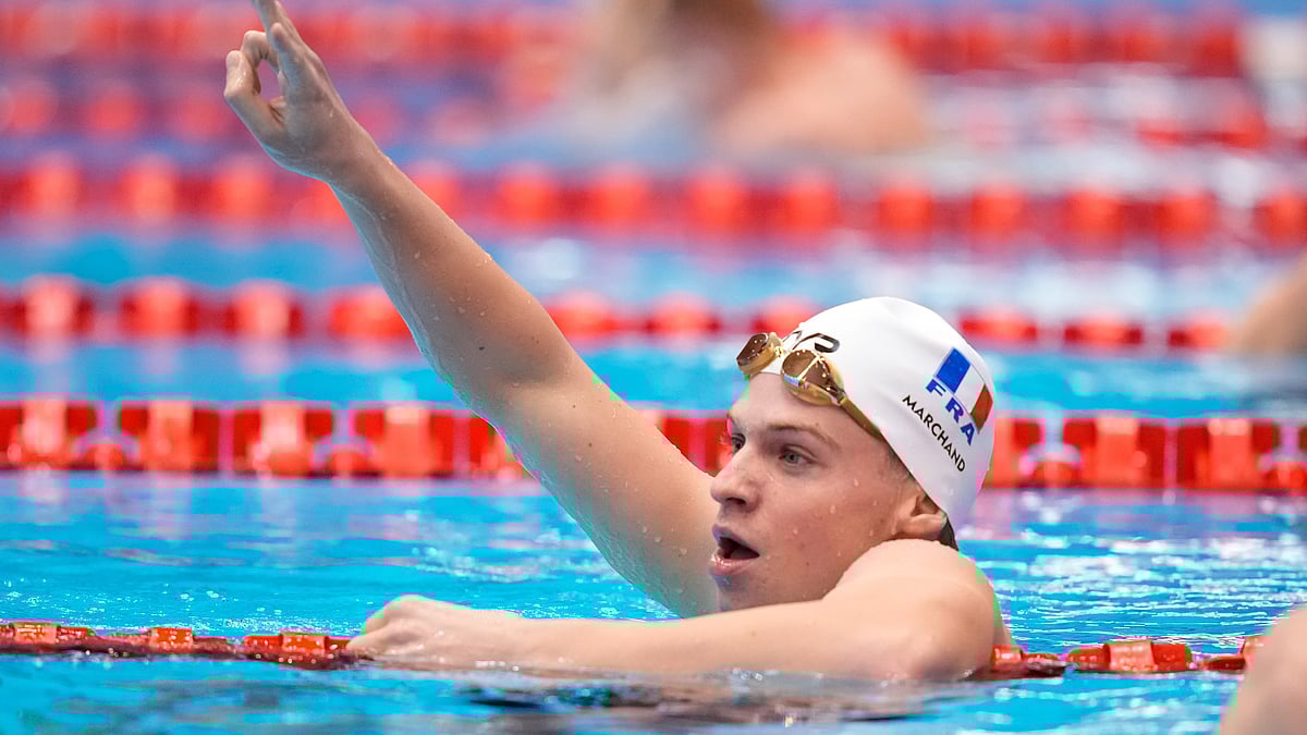 FILE - Leon Marchand of France celebrates after winning the men's 200m individual medley final at the World Swimming Championships in Fukuoka, Japan, Thursday, July 27, 2023. Marchand has drawn comparisons to Michael Phelps, a link that was only strengthened by Phelps’ longtime coach, Bob Bowman, overseeing the 22-year-old’s rise to prominence.  - (AP Photo/Eugene Hoshiko, File)